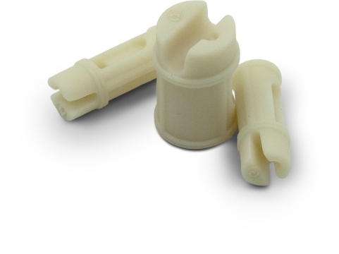 Machined plastic components, likely used in a mechanical or industrial application