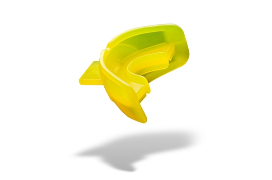 Yellow plastic molded mouth guard with smooth and contoured shape