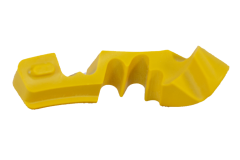 Bone plate drill guide made from yellow machined plastic, featuring a unique contoured shape for precise surgical application
