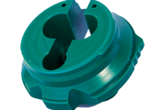 Green circular machined plastic component, featuring intricate details, used in high-precision applications.