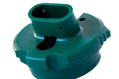 Machined green plastic component with intricate details, designed for high-precision applications.
